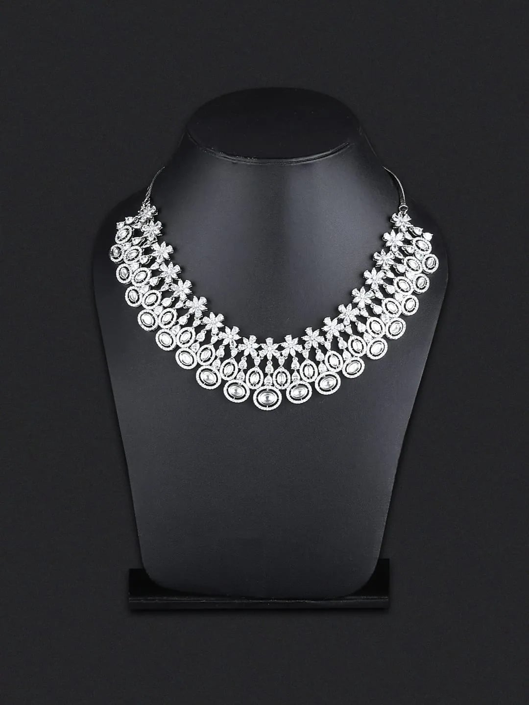 Diamond statement necklace displayed on a black velvet bust